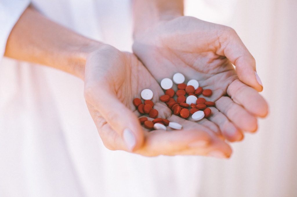 a person holding a heart shaped candy