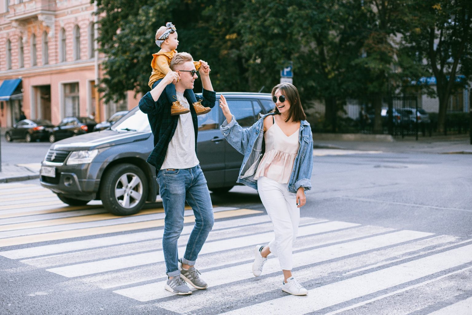 a group of people standing in a parking lot with a dog