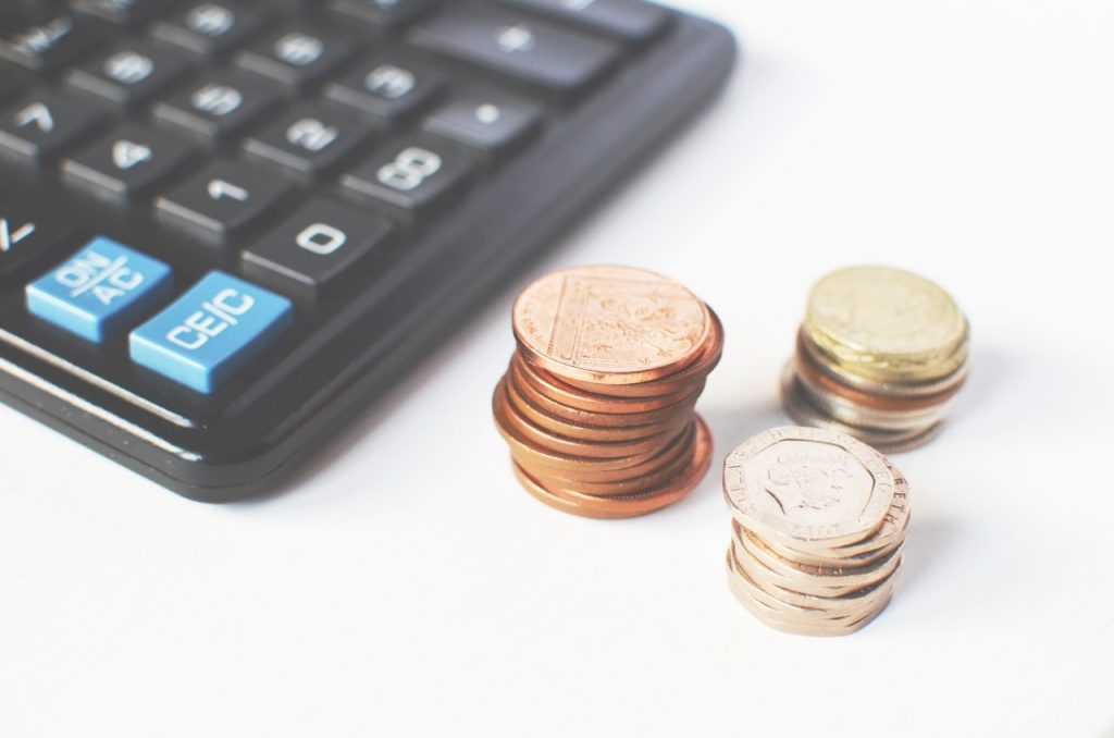 a group of coins next to a keyboard