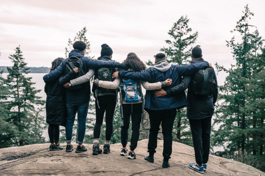 a group of people standing on a hill