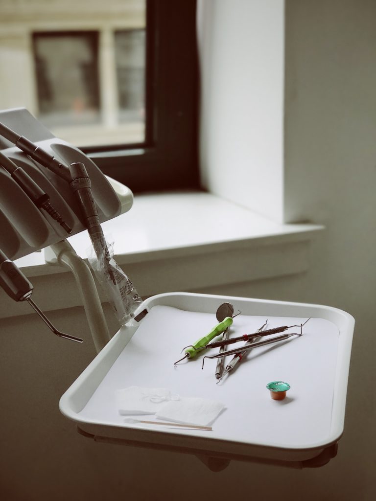 a green lizard on a white chair