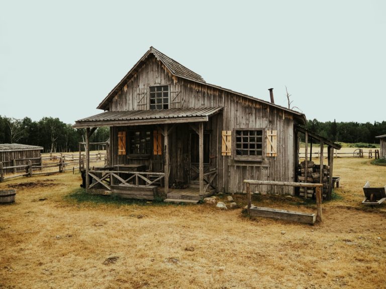 a wooden house in a field
