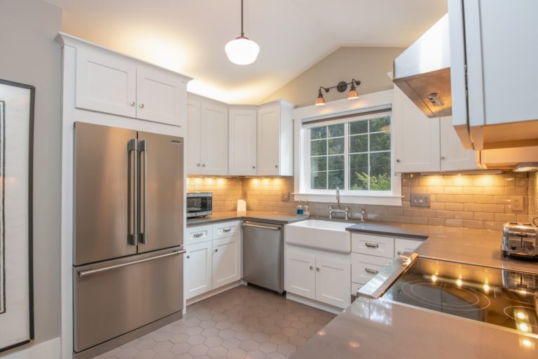 a kitchen with a stainless steel refrigerator