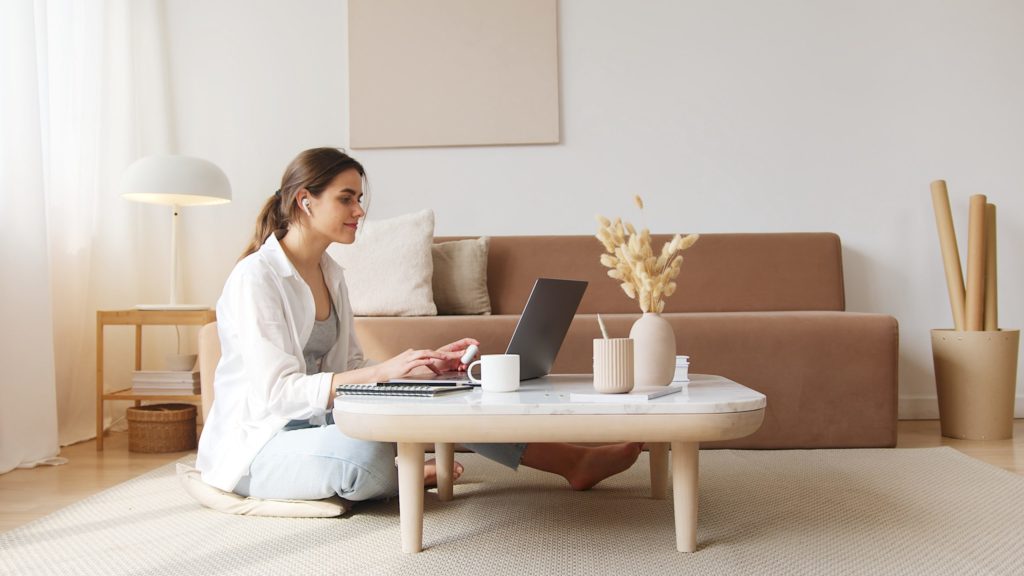 a person sitting on a couch with a laptop