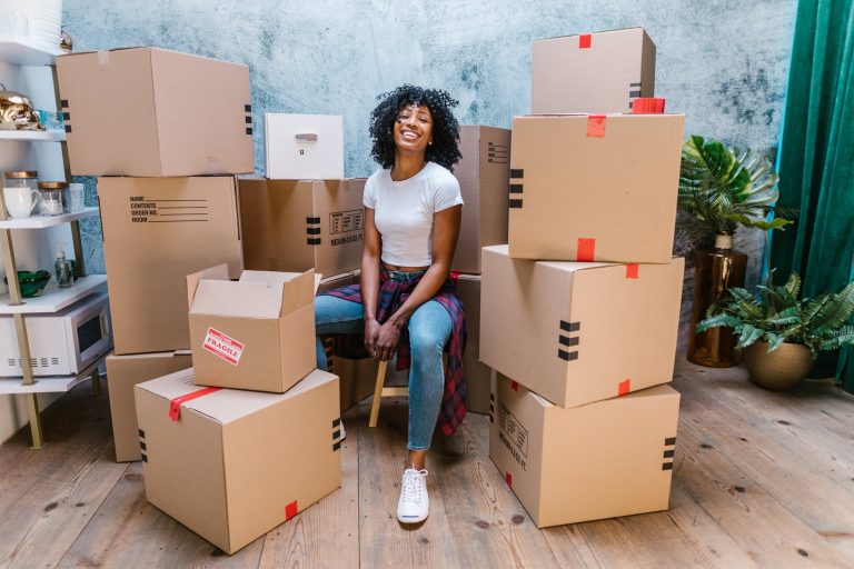 a person sitting in a chair with boxes on the floor