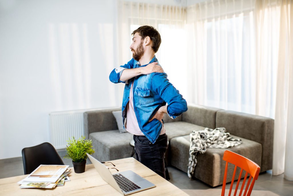 a person standing in front of a laptop