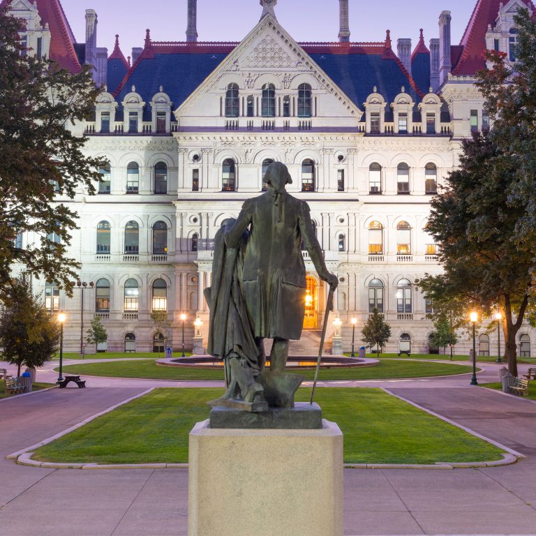 a statue in front of a large building