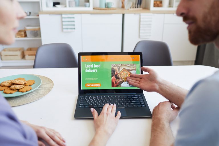 a man and woman looking at a tablet