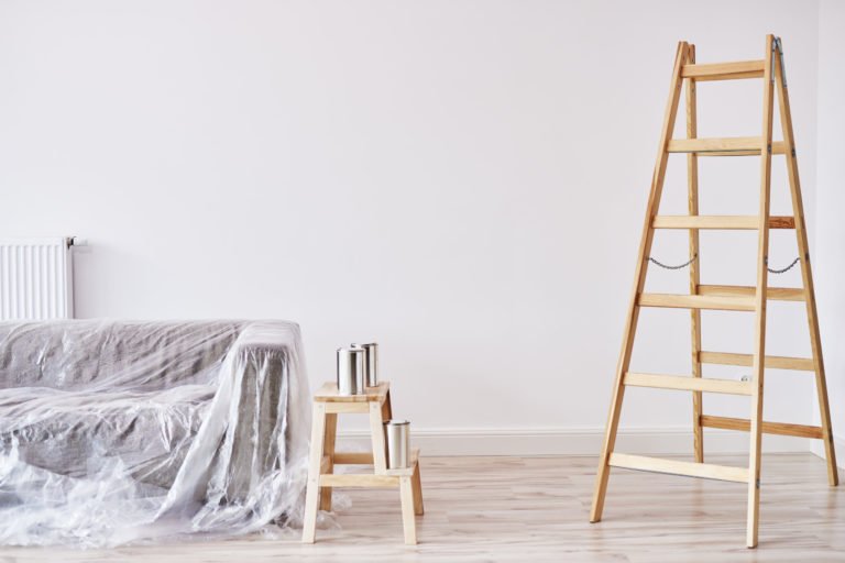 a ladder and a bed in a room